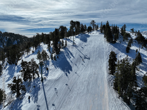Ski lift seat on snowing mountain, cable way in ski resort.