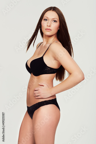 Shes got real Curves. A voluptuous model posing against a white background. © Sanne B/peopleimages.com