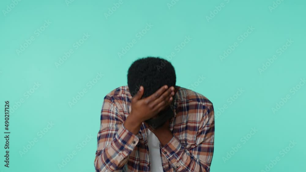 African american man wearing medical mask on his face coughing suffering from bronchitis asthma allergy, Coronavirus feels symptoms of Covid-19 pneumonia disease. Adult guy alone on blue background African american man wearing medical mask on his face coughing suffering from bronchitis asthma allergy, Coronavirus feels symptoms of Covid-19 pneumonia disease. Adult guy alone on blue background