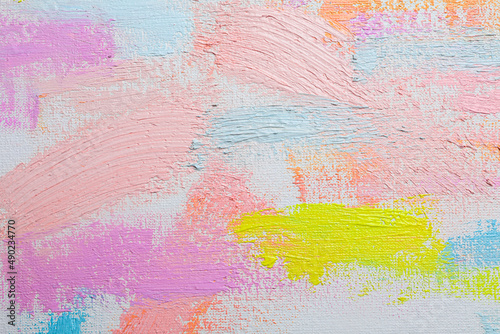 Strokes of different pastel acrylic paints on white canvas, closeup