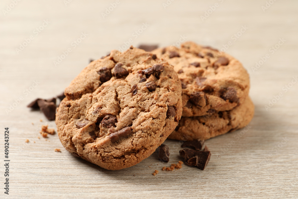 Delicious chocolate chip cookies on wooden table, closeup Delicious chocolate chip cookies on wooden table, closeup