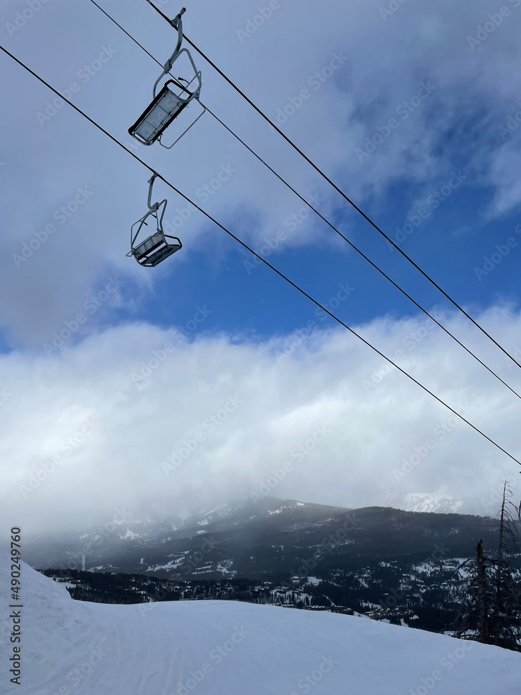 Scenic view of the chairlift and slopes at Big Sky Ski Resort on a sunny winter day Scenic view of the chairlift and slopes at Big Sky Ski Resort on a sunny winter day