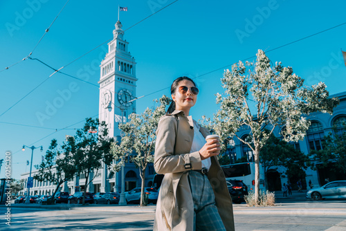 Photography busy beautiful asian japanese woman manager with coffee walking near ferry building in san francisco