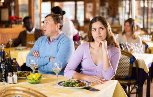 Quarreled visitors female and male at a restaurant on celebrate