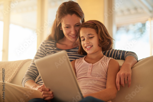 When it comes to technology, shes a natural. Cropped shot of a mother and her daughter using wireless technology at home.