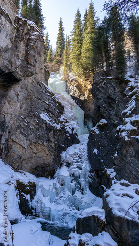 Beautiful frozen waterfall in a mountain gorge