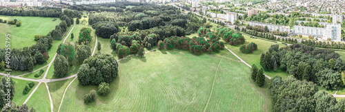 aerial panoramic view of city park among residential district in summer day