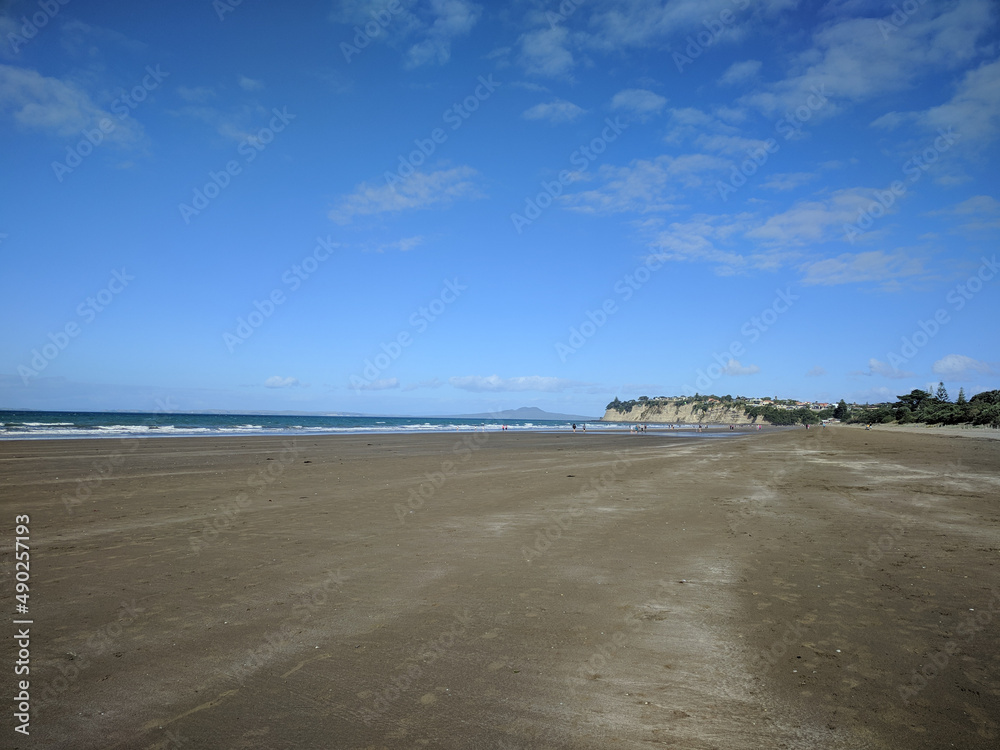 Long Bay beach, sea and Rangitoto island on background, New Zealand. Long Bay beach, sea and Rangitoto island on background, New Zealand.