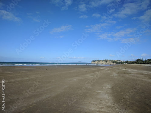 Long Bay beach, sea and Rangitoto island on background, New Zealand.
