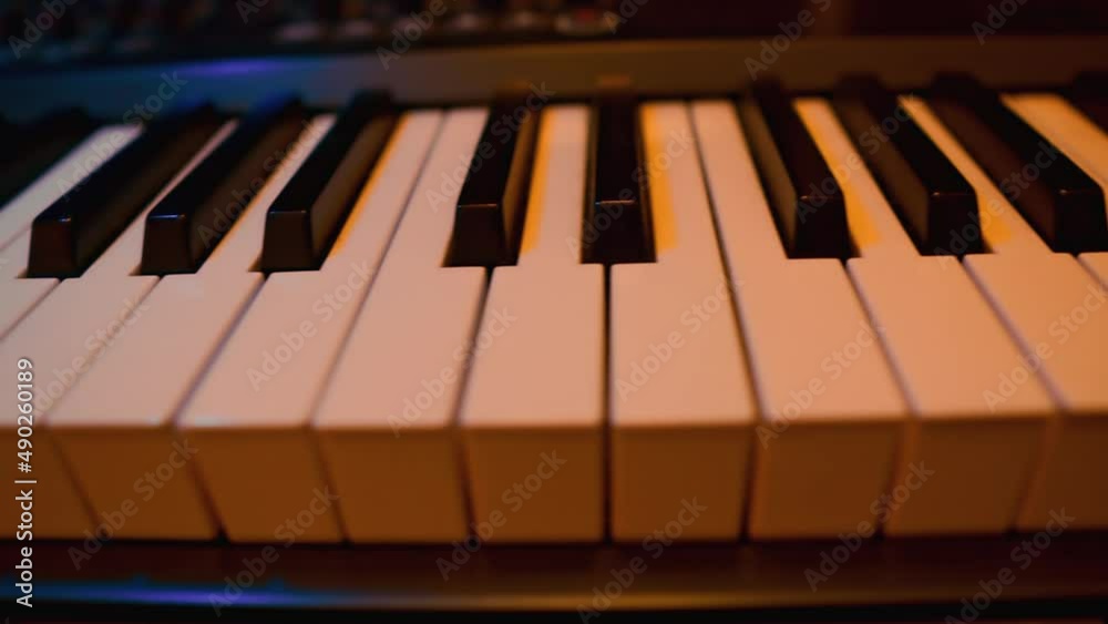 Midi Keys Keyboards. Piano Keys Moving. Black and White Keys. Colorful Neon Light. Tracking Backwards Shot. Close Up Midi Keys Keyboards. Piano Keys Moving. Black and White Keys. Colorful Neon Light. Tracking Backwards Shot. Close Up