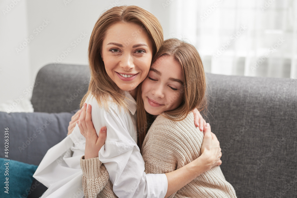 Mother and daughter hugging at home Mother and daughter hugging at home