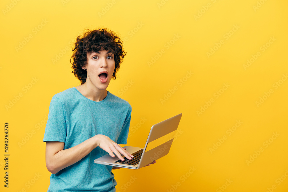 freelancer in blue t-shirts with laptop internet yellow background freelancer in blue t-shirts with laptop internet yellow background