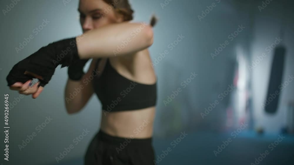 Slow motion, female fighter trains his punches and defense, training in the boxing gym, woman power. Slow motion, female fighter trains his punches and defense, training in the boxing gym, woman power.