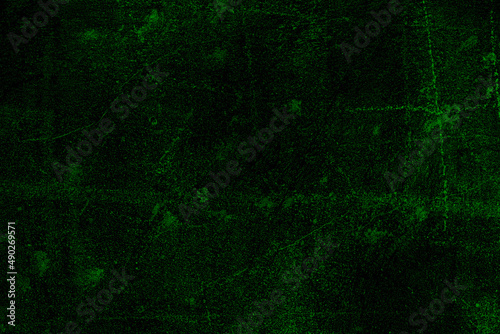 Dark green color rough grunge textured surface of aged cement plaster wall for background