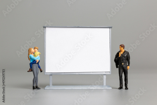 Miniature people at The front of a whiteboard © Sirichai Puangsuwan