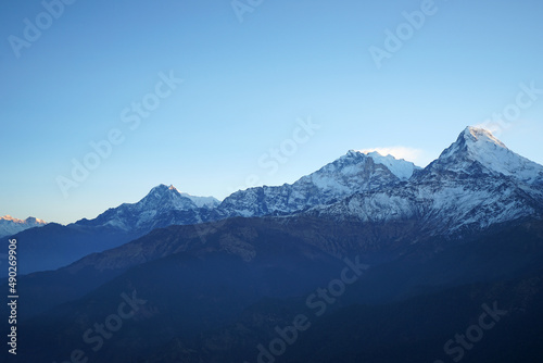 Fototapeta Naklejka Na Ścianę i Meble -  Natural landscape of Snowcapped mountain view of Poon hill with colorful prayer flags and blue sky, Annapurna Himalayan range- Ghorepani, Nepal