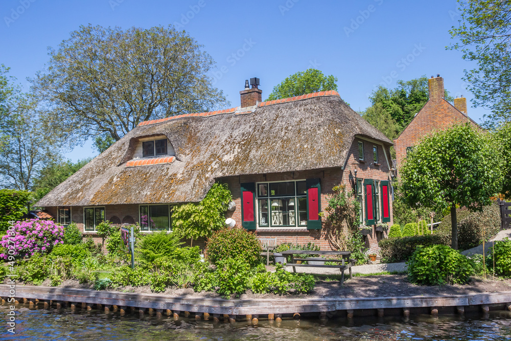 Old house with colorful shutters in at the canal in Giethoorn, Netherlands