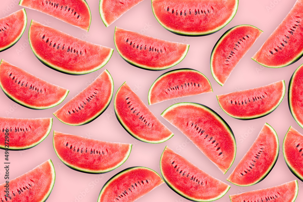 Watermelon cut into small pieces with shell are arranged on pink background. Watermelon cut into small pieces with shell are arranged on pink background.