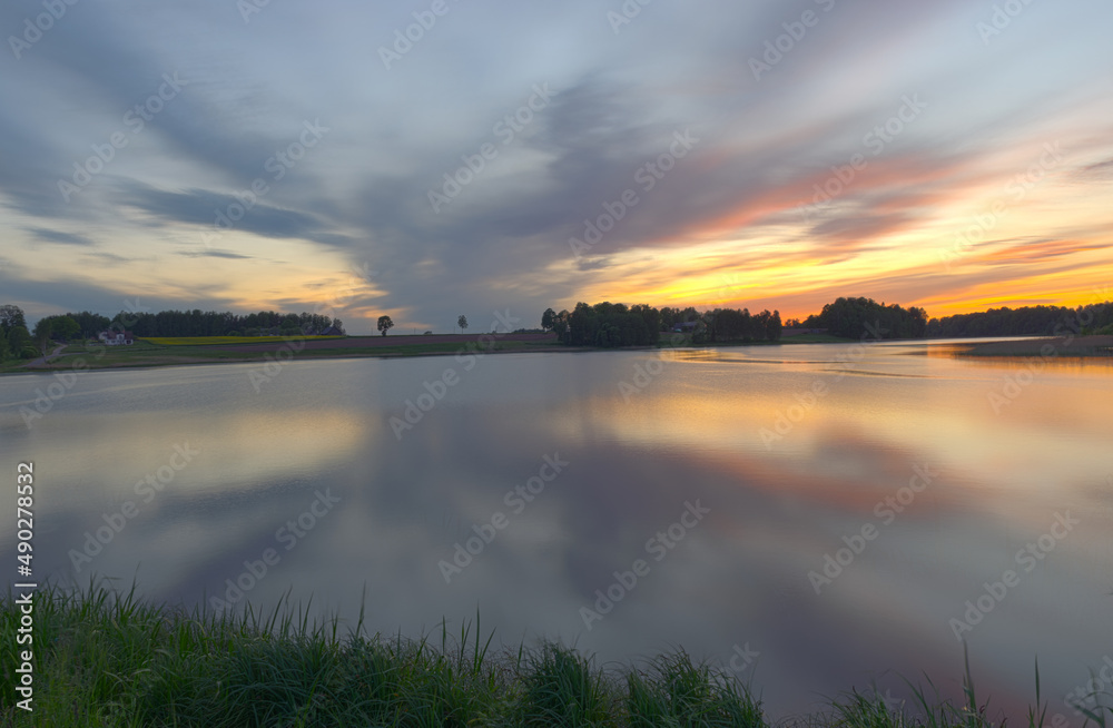 blurred panoramic view, colorful sunset landscape on the lake, long-term exposure