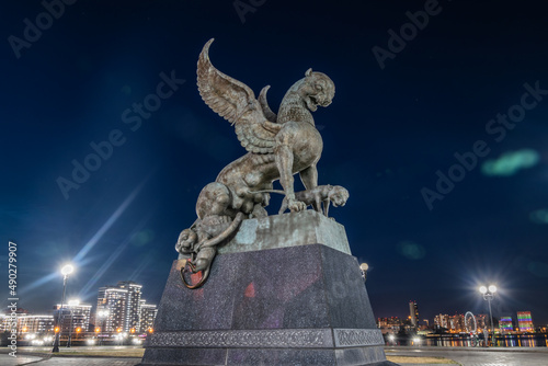 Family center and wedding palace with lighting at night, Kazan, Tatarstan. Statue of winged panther at dusk close-up. This place is landmark of Kazan. Travel concept.