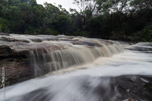Flowing rocky cascade after rainy days.