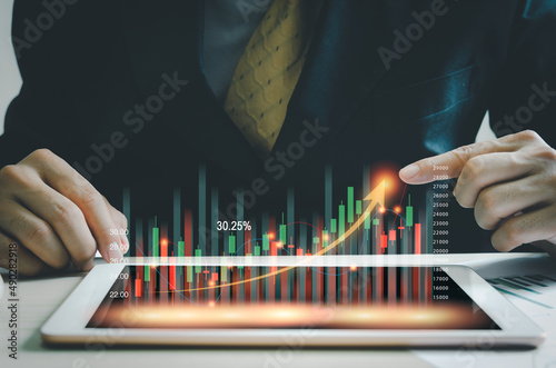 business concept.stock market finance.Index Fund.businessman holding a graph tablet showing growing virtual hologram stocks. invest in trading