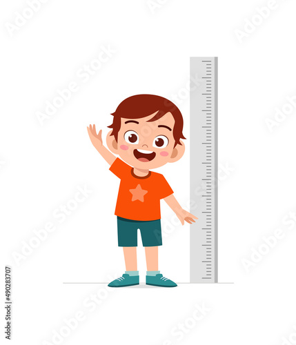 cute little boy measure height for grow progress
