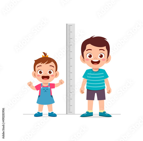 boy and girl measure height and compare grow progress