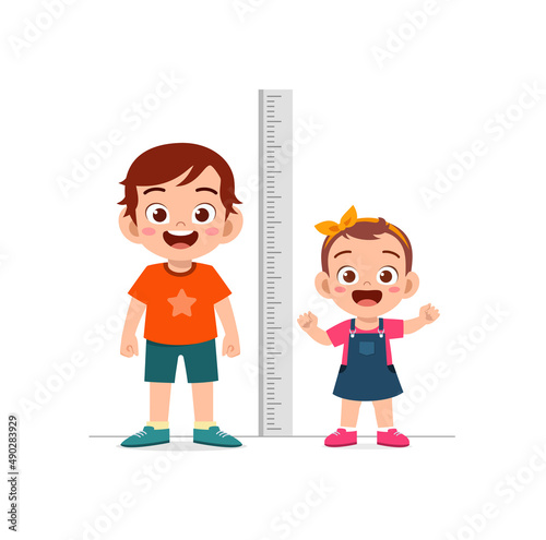 boy and girl measure height and compare grow progress photo