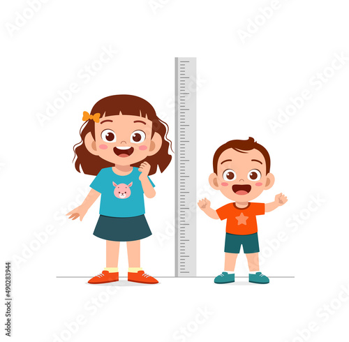 boy and girl measure height and compare grow progress