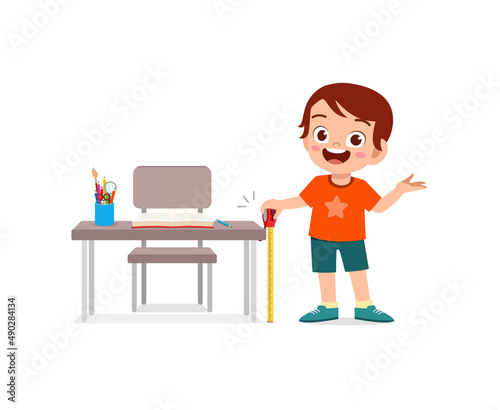 boy holding measure tape and check length of table