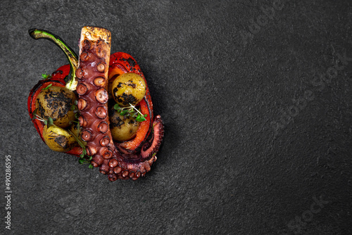 Sea delicacy grilled octopus. Dish on a dark background