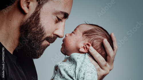 Obraz na płótnie portrait of man looking at his newborn son with loving expression