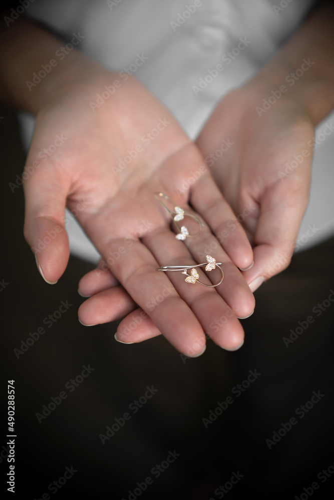 Gold jewelry chain long earrings pendant on the hands