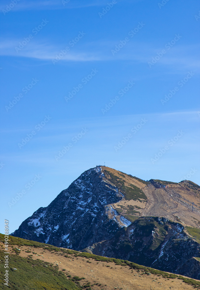 Beautiful mountain landscapes with peaks and valleys against a clear blue sky