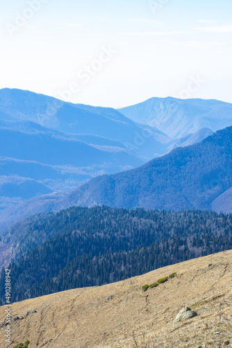 Beautiful mountain landscapes with peaks and valleys against a clear blue sky