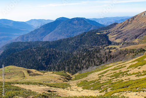 Beautiful mountain landscapes with peaks and valleys against a clear blue sky