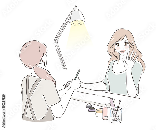 ネイルサロンで施術を受けるかわいい女性