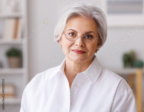 Delighted mature businesswoman in home office