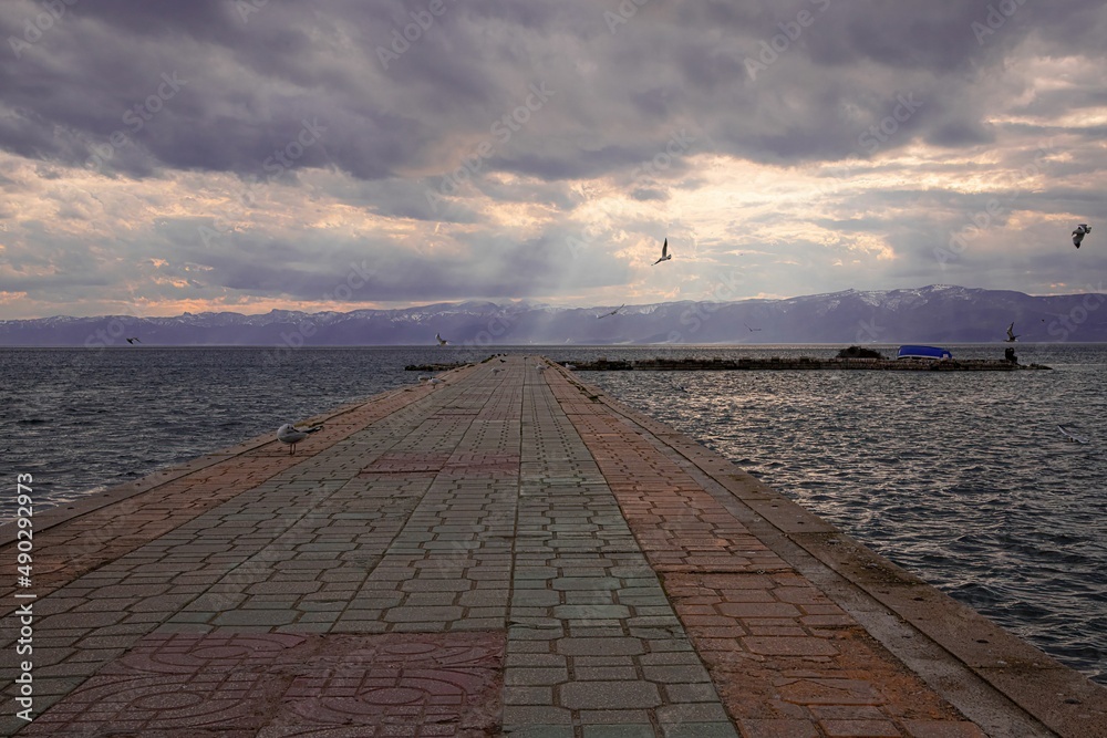 pier leading into the water of lake ohrid in Macedonia on a cloudy day