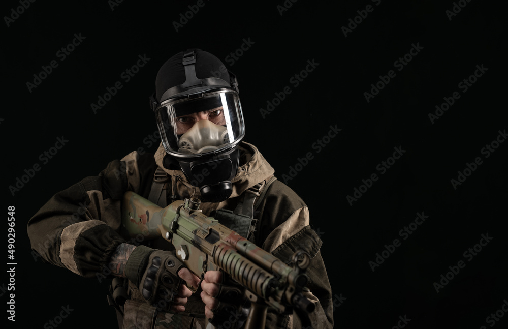 a man in a military uniform and a gas mask holds a weapon with an angry expression of emotion