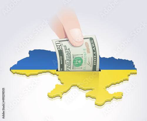 A hand drops a 20 dollar bill into a map of Ukraine in the colors of the Ukrainian flag
