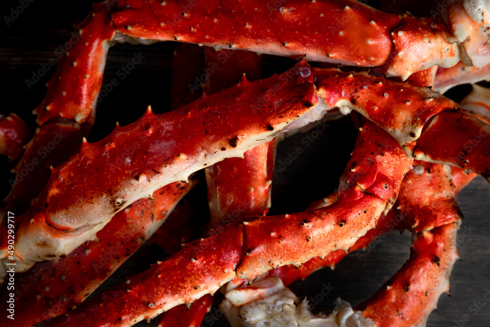 crab phalanx, sea delicacy on a dark background. large red Kamchatka crab claws phalanx legs tentacles crab phalanx, sea delicacy on a dark background. large red Kamchatka crab claws phalanx legs tentacles