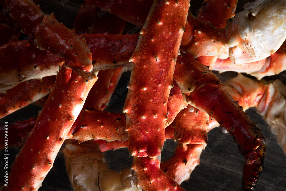 crab phalanx, sea delicacy on a dark background. large red Kamchatka crab claws phalanx legs tentacles crab phalanx, sea delicacy on a dark background. large red Kamchatka crab claws phalanx legs tentacles