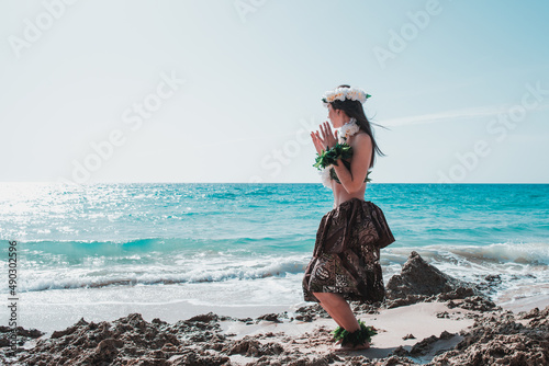 Hawaiian woman enjoys hula dancing on the beach barefoot wearing traditional costume. Unrecognizable hawaiian hula dance dancing attire hawai.
