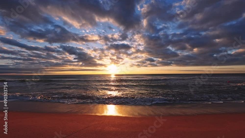 Beautiful sunrise over the sea and beach. Sunset over ocean waves.