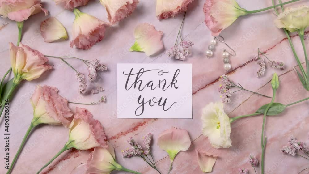 MOTHER’s DAY card on a marble table near pink flowers top view MOTHER’s DAY card on a marble table near pink flowers top view