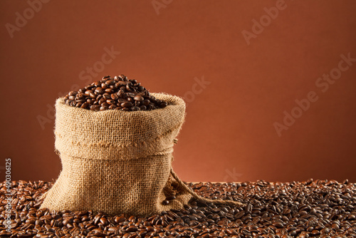 Coffee beans and bag on old rusty background