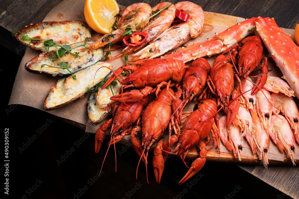 a plate of various snacks, seafood, mussels, boiled crayfish, shrimps a plate of various snacks, seafood, mussels, boiled crayfish, shrimps