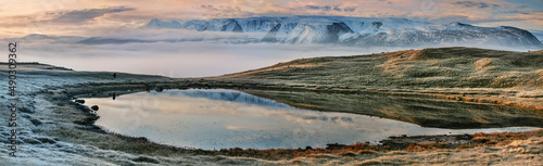 Mountain lake on a foggy morning, panoramic view, harsh northern nature